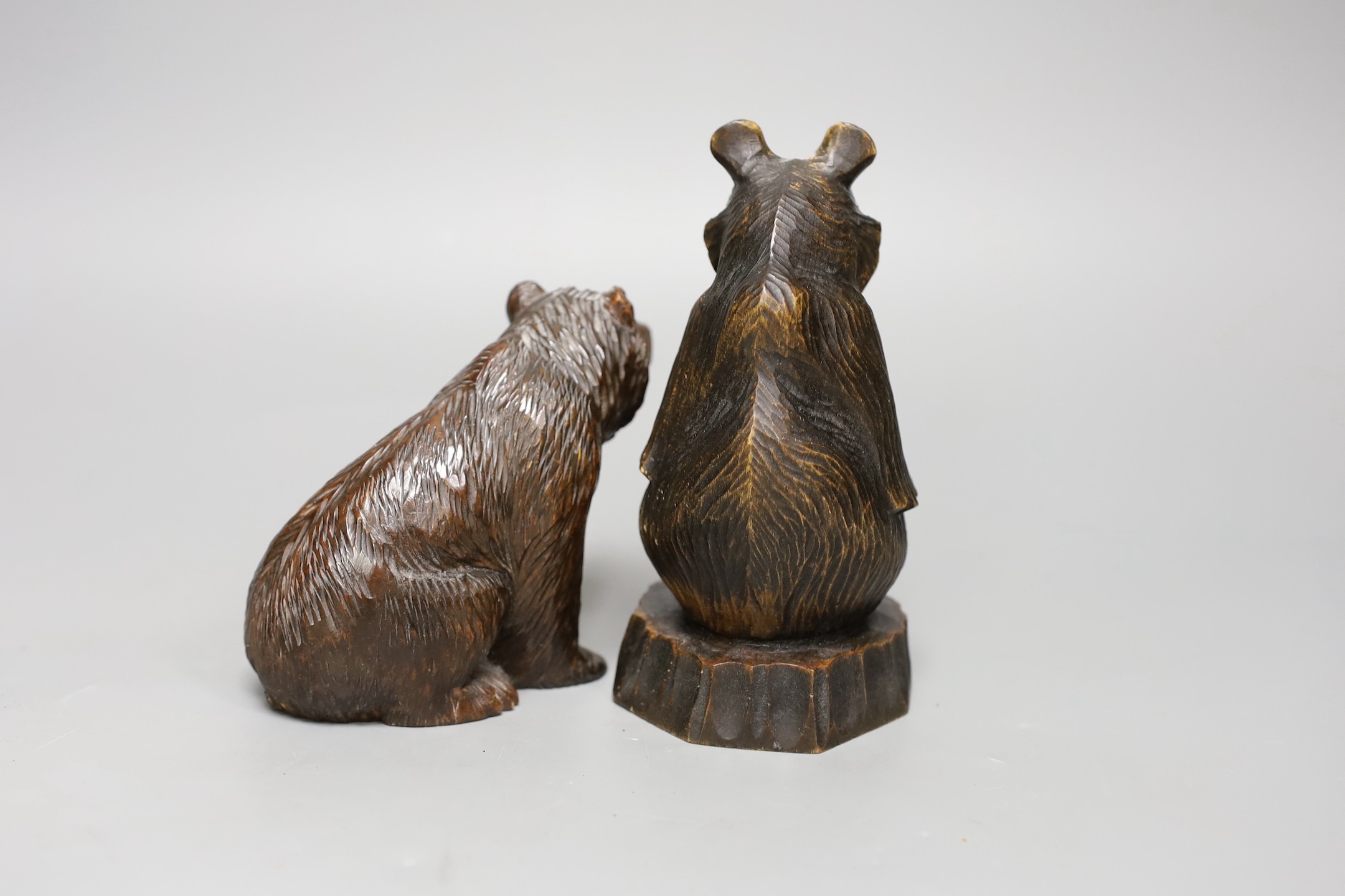 A Black Forest carved bear and a similar Japanese seated model of a bear, 15.5cm